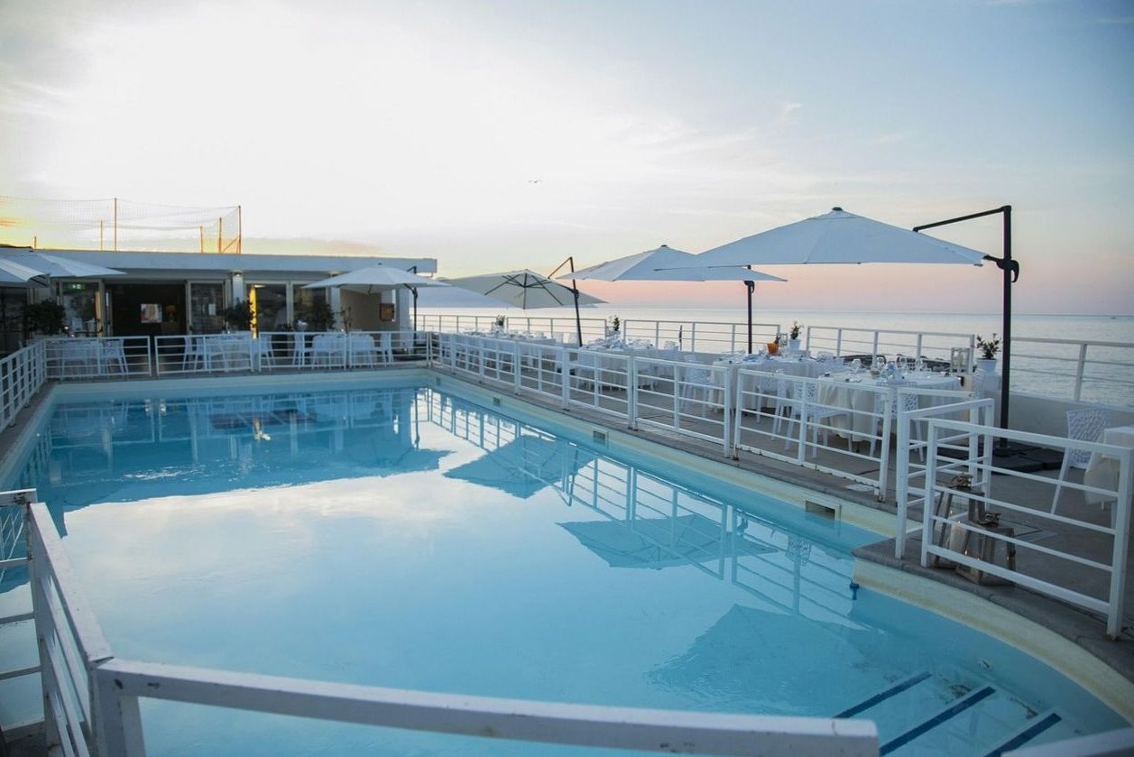 Rooftop pool terrace at sunset at Plain Scope Agency